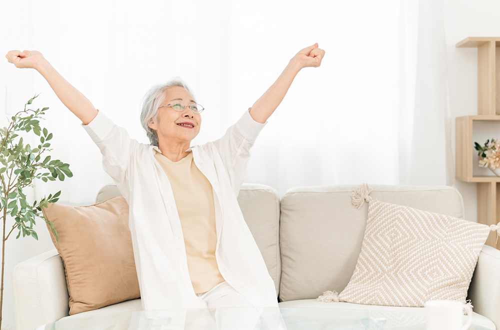 元気に伸びをする高齢の女性の画像
